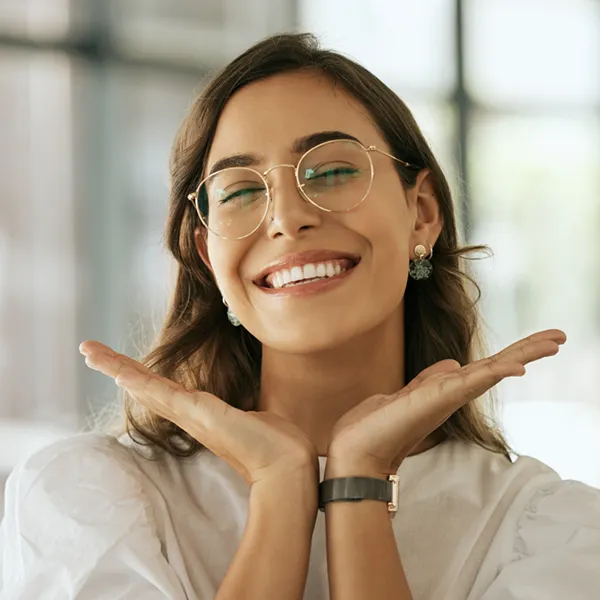 woman using her hands to showcase her beautiful smile
