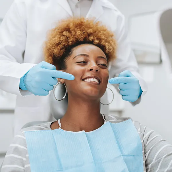 young adult woman smiling in patient chair