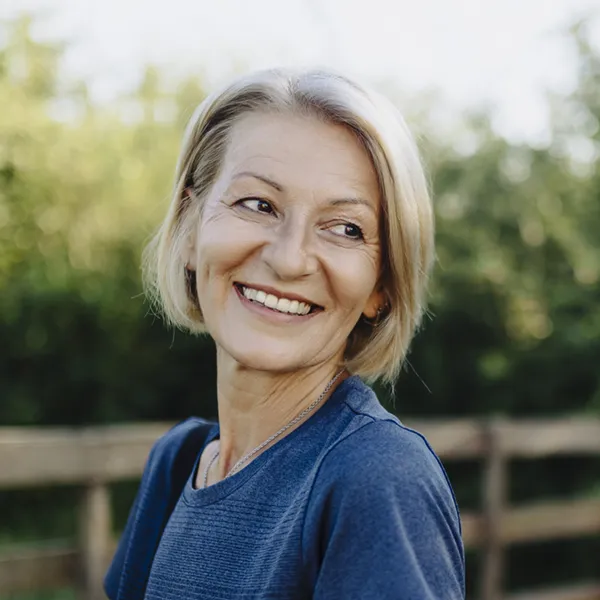 mature woman looking over her shoulder and smiling