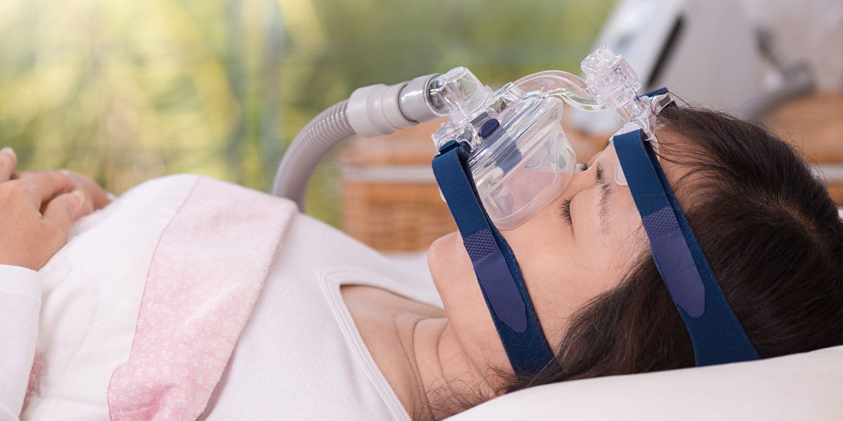 person sleeping with CPAP machine